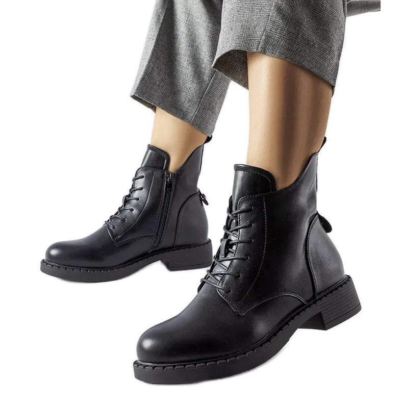 Black asymmetric flat boots by Solza