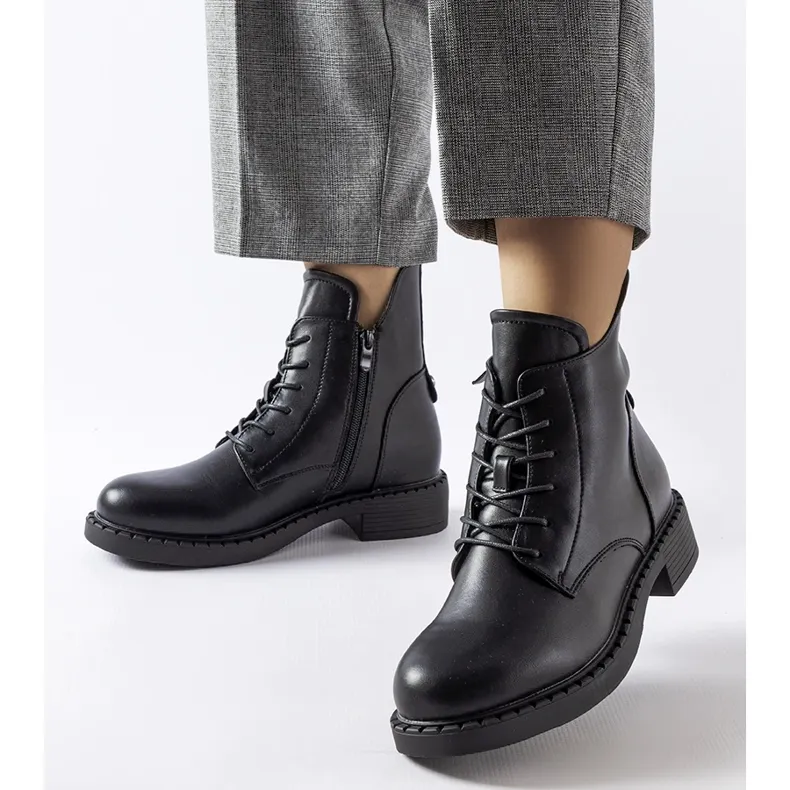 Black asymmetric flat boots by Solza